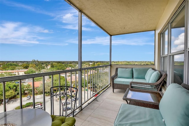 balcony featuring a sunroom and an outdoor hangout area