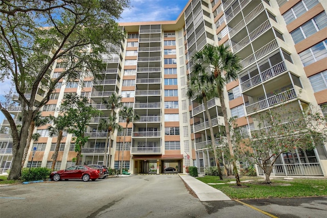 10777 W Sample Rd Unit 912, Coral Springs, FL 33065 - view of apartment building / complex featuring uncovered parking