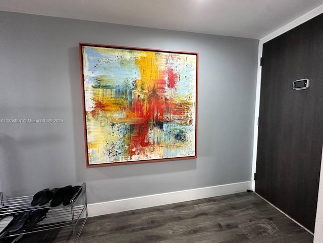 interior space with baseboards and dark wood finished floors