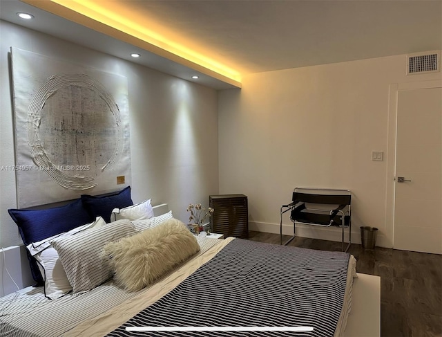 bedroom with recessed lighting, visible vents, baseboards, and wood finished floors