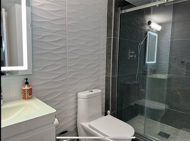 full bath with toilet, a stall shower, tile walls, and vanity