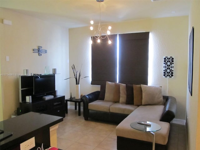 living room with a chandelier, baseboards, and light tile patterned floors