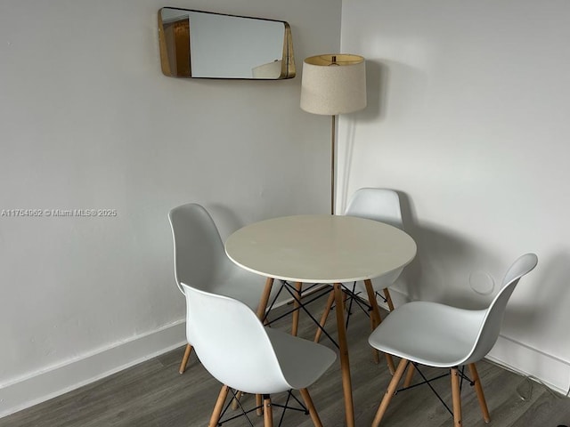 dining area with wood finished floors and baseboards