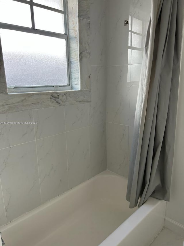 bathroom featuring shower / bath combination with curtain