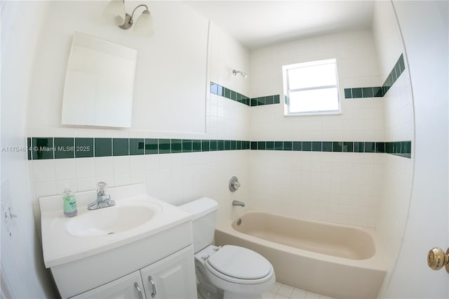 bathroom with toilet, shower / washtub combination, tile walls, and vanity