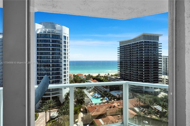 balcony with a water view and a city view