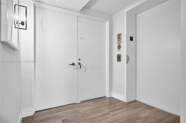 entrance foyer featuring elevator and wood finished floors