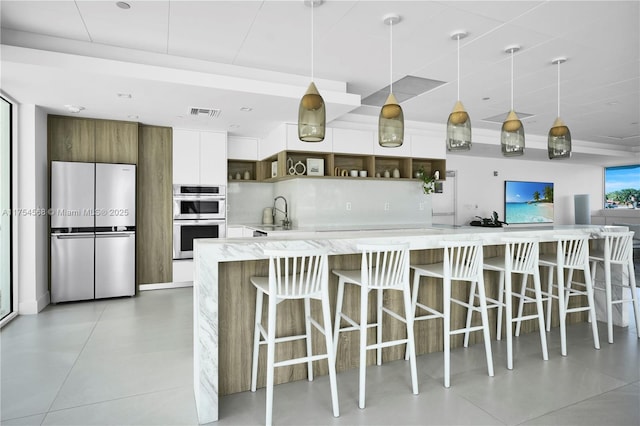 kitchen featuring tasteful backsplash, hanging light fixtures, stainless steel appliances, white cabinetry, and open shelves