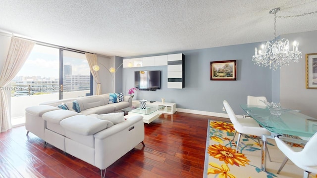 living room with a notable chandelier, a textured ceiling, baseboards, and dark wood-style flooring