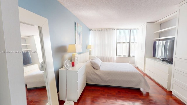 bedroom featuring dark wood-type flooring and a textured ceiling