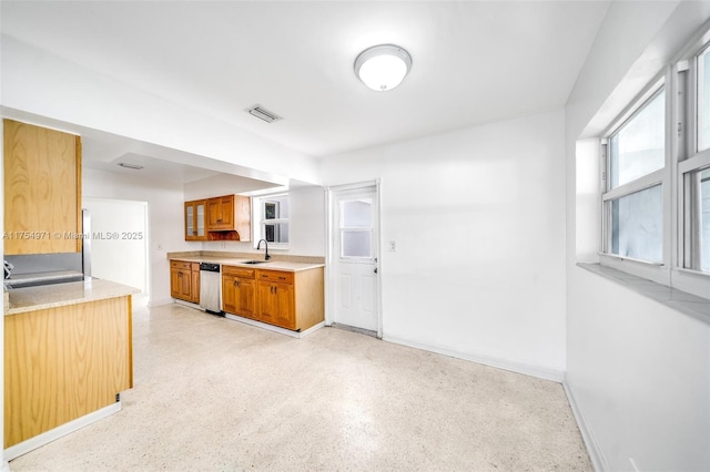 kitchen with light countertops, visible vents, a sink, and stainless steel dishwasher