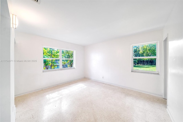 spare room featuring speckled floor