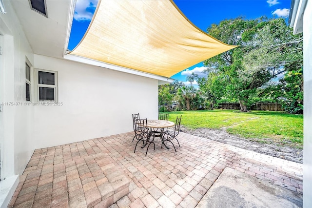 view of patio / terrace with outdoor dining space and fence