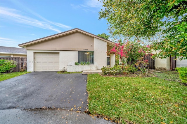 13456 SW 108th St Cir N, Miami, FL 33186 - mid-century modern home featuring stucco siding, fence, driveway, a front yard, and a garage