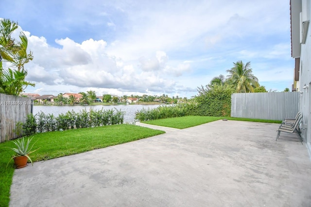 view of patio / terrace with a water view and fence