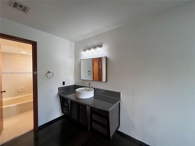 bathroom with baseboards, visible vents, and vanity