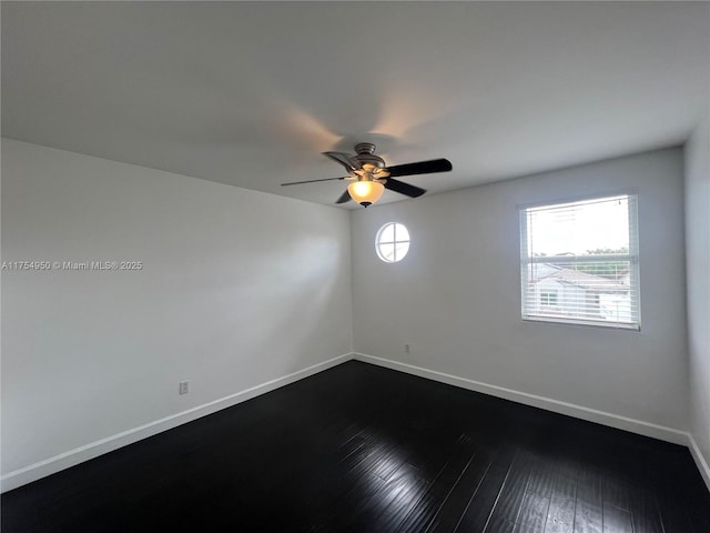 unfurnished room featuring a ceiling fan, baseboards, dark wood finished floors, and a wealth of natural light