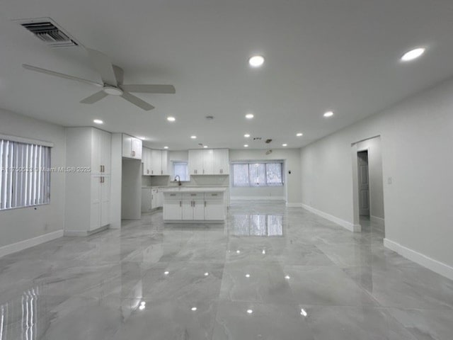 unfurnished living room featuring baseboards, visible vents, ceiling fan, marble finish floor, and recessed lighting