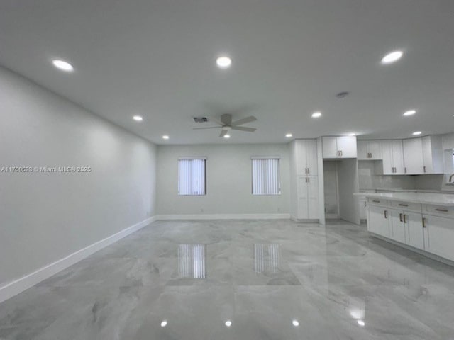 interior space featuring visible vents, baseboards, a ceiling fan, and recessed lighting