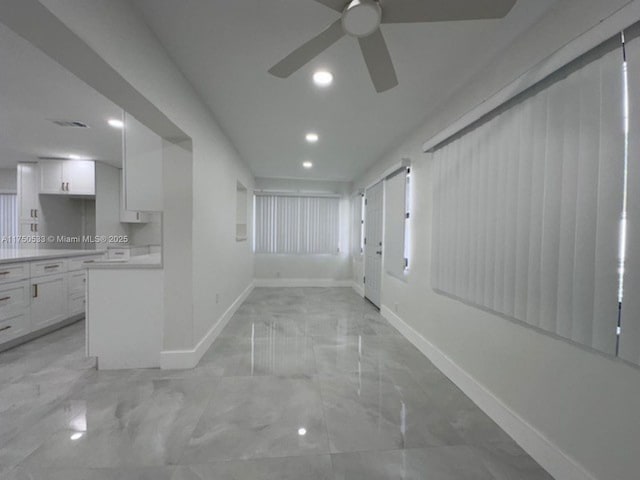 spare room with marble finish floor, recessed lighting, visible vents, a ceiling fan, and baseboards