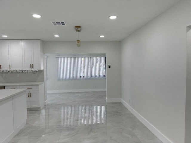 unfurnished dining area featuring recessed lighting, visible vents, and baseboards