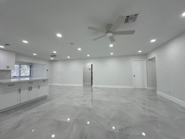 interior space with recessed lighting, marble finish floor, visible vents, and baseboards