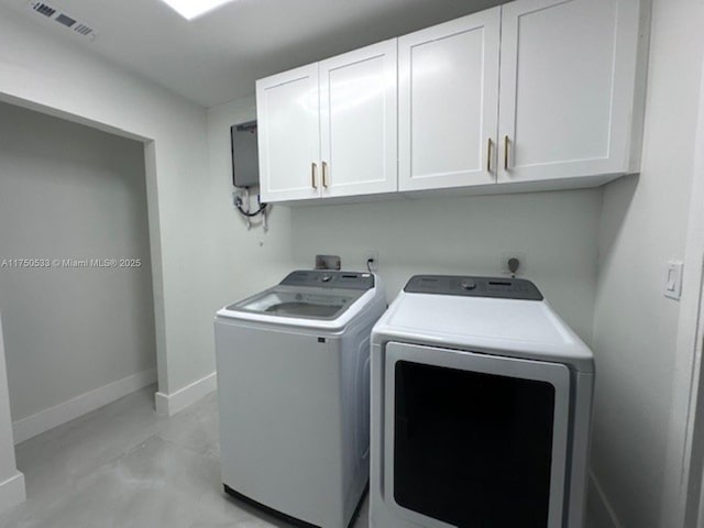 clothes washing area with cabinet space, baseboards, visible vents, and washer and clothes dryer