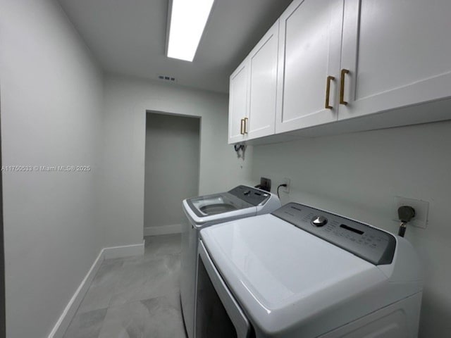 laundry room with marble finish floor, washing machine and clothes dryer, visible vents, cabinet space, and baseboards