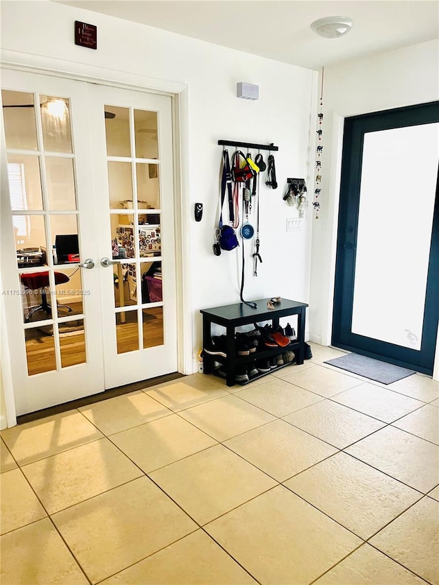 doorway to outside with tile patterned flooring and french doors