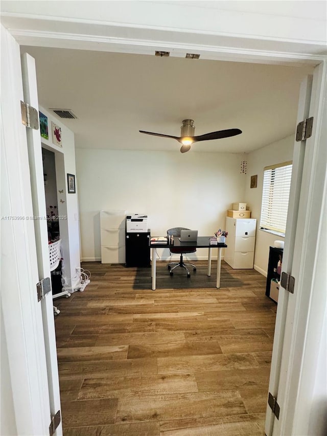office with visible vents, baseboards, a ceiling fan, and wood finished floors