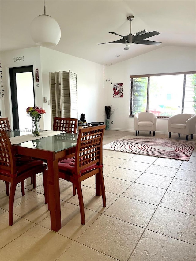 dining room with light tile patterned floors, visible vents, vaulted ceiling, and ceiling fan