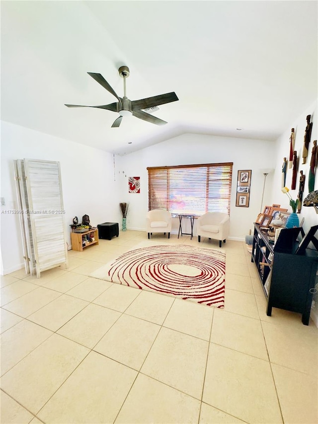 living room featuring tile patterned flooring, a ceiling fan, and lofted ceiling