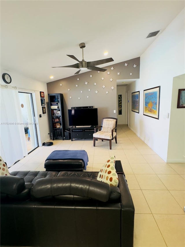 living area featuring light tile patterned floors, visible vents, ceiling fan, and lofted ceiling
