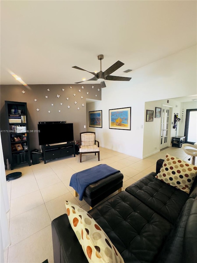 living area with vaulted ceiling, french doors, a ceiling fan, light tile patterned flooring, and visible vents