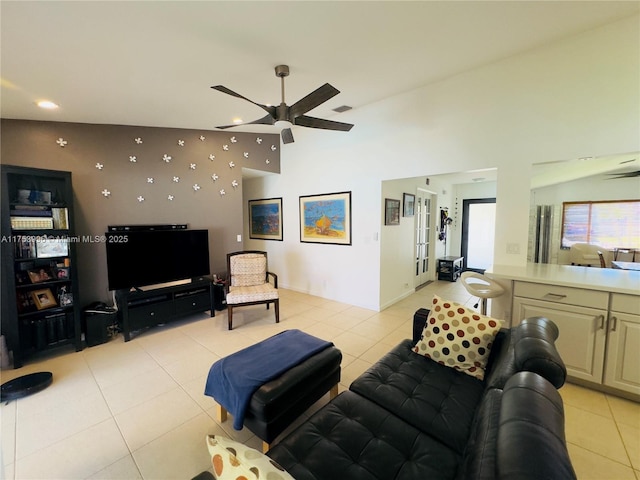 living room with light tile patterned floors, visible vents, a ceiling fan, vaulted ceiling, and french doors