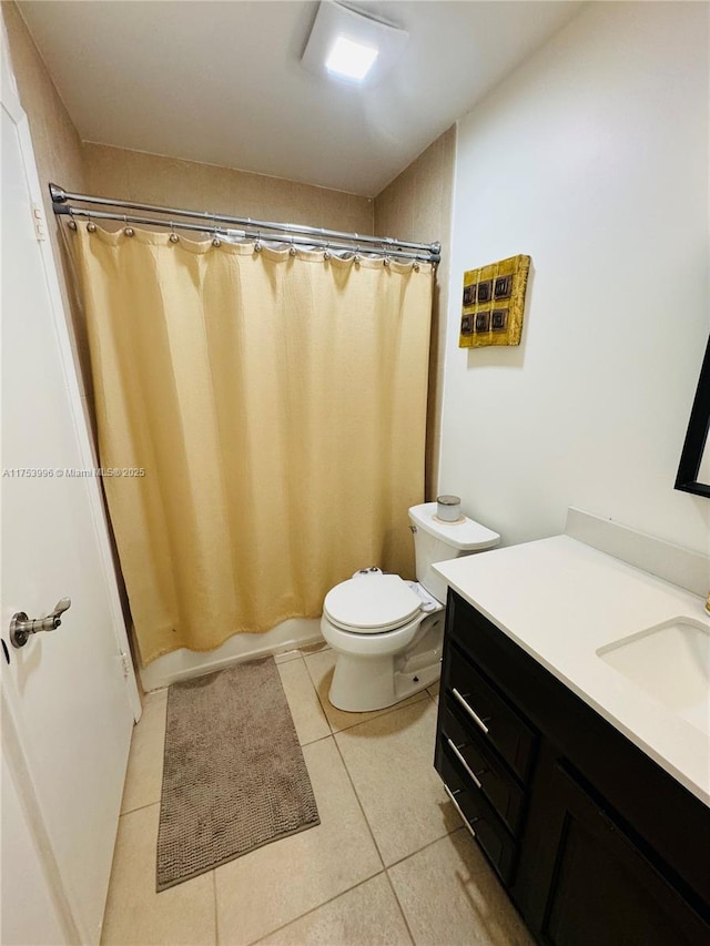full bathroom with shower / tub combo, toilet, tile patterned flooring, and vanity