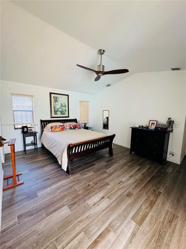 bedroom with visible vents, baseboards, a ceiling fan, wood finished floors, and lofted ceiling