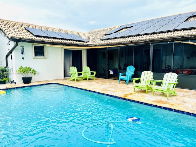 pool featuring a sunroom and a patio