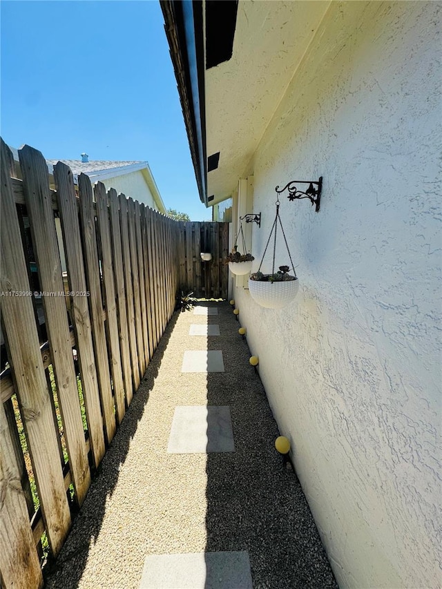 view of property exterior featuring stucco siding and fence