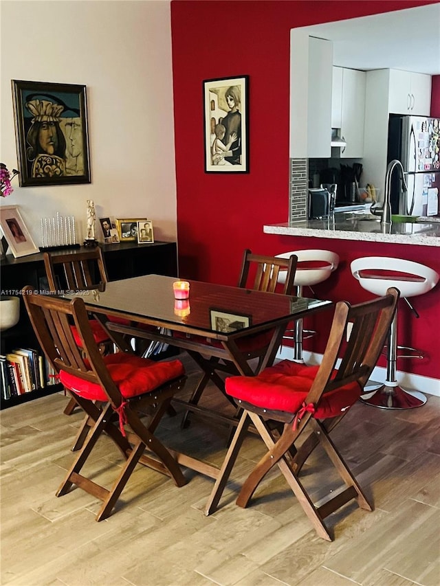 dining room with light wood finished floors