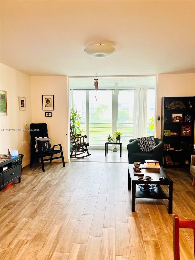 living room with light wood-style flooring and expansive windows