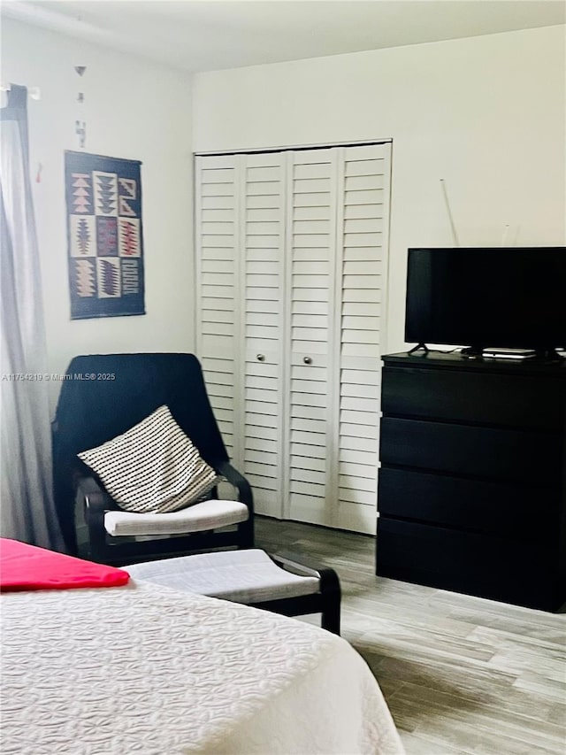 bedroom featuring a closet and wood finished floors