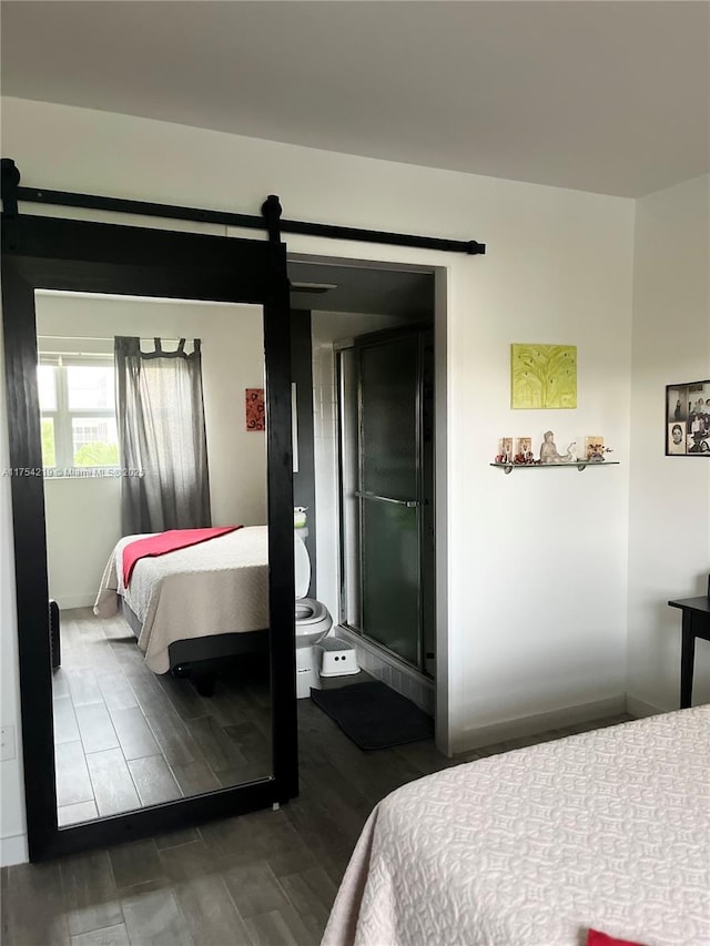 415 SE 11th Ter Unit 205, Dania Beach, FL 33004 - bedroom featuring a barn door, wood finished floors, and baseboards