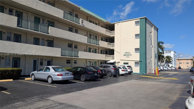 view of building exterior with uncovered parking