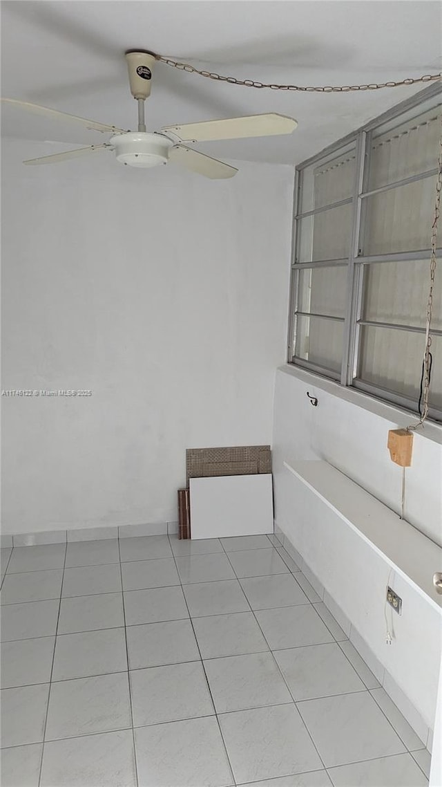 unfurnished dining area featuring ceiling fan and light tile patterned floors