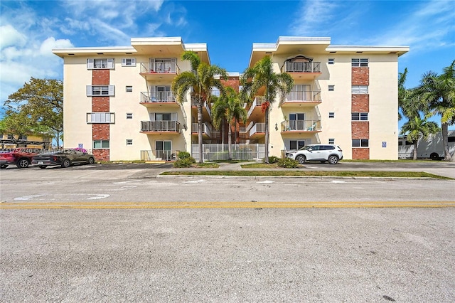 view of building exterior with uncovered parking