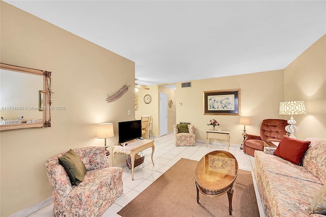 living area with visible vents, ceiling fan, and light tile patterned flooring