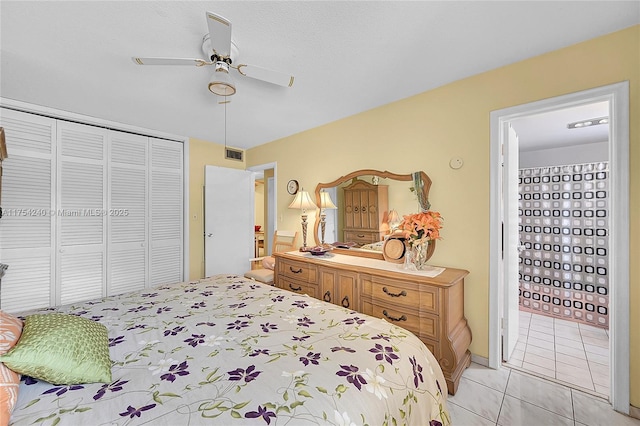 bedroom featuring ceiling fan, visible vents, a closet, and light tile patterned flooring