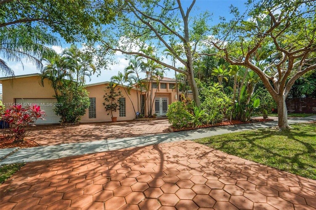 view of front of home featuring a garage, french doors, and stucco siding