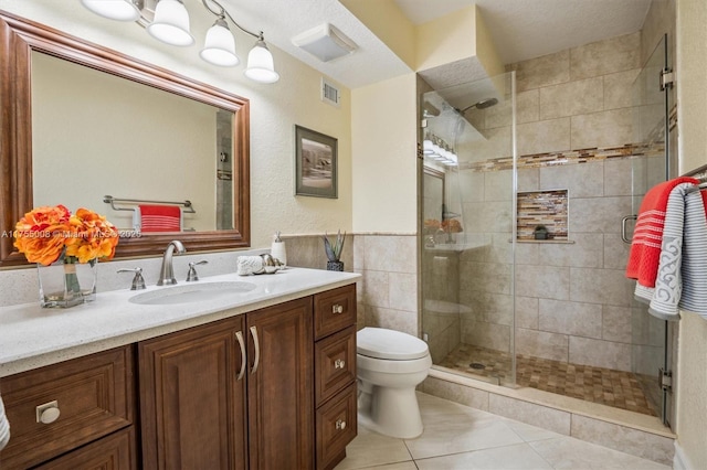 full bathroom featuring visible vents, toilet, tile patterned floors, vanity, and a shower stall